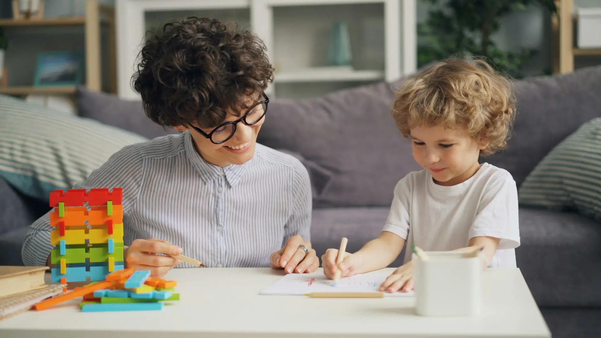 Professional IB tutor teaching mathematics to student at home in modern Dubai villa