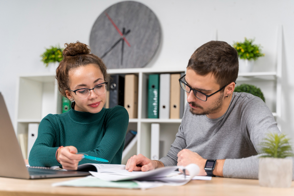 A specialized private IELTS tutor in Dubai providing personalized, in-person instruction to a student, demonstrating a focused, one-on-one learning environment.