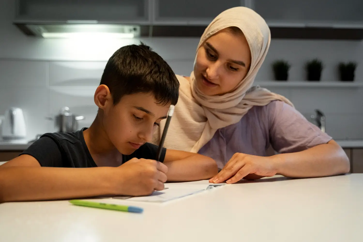 Child learning Arabic reading and writing at home with the guidance of a skilled private Arabic tutor in Dubai, focused on engaged learning