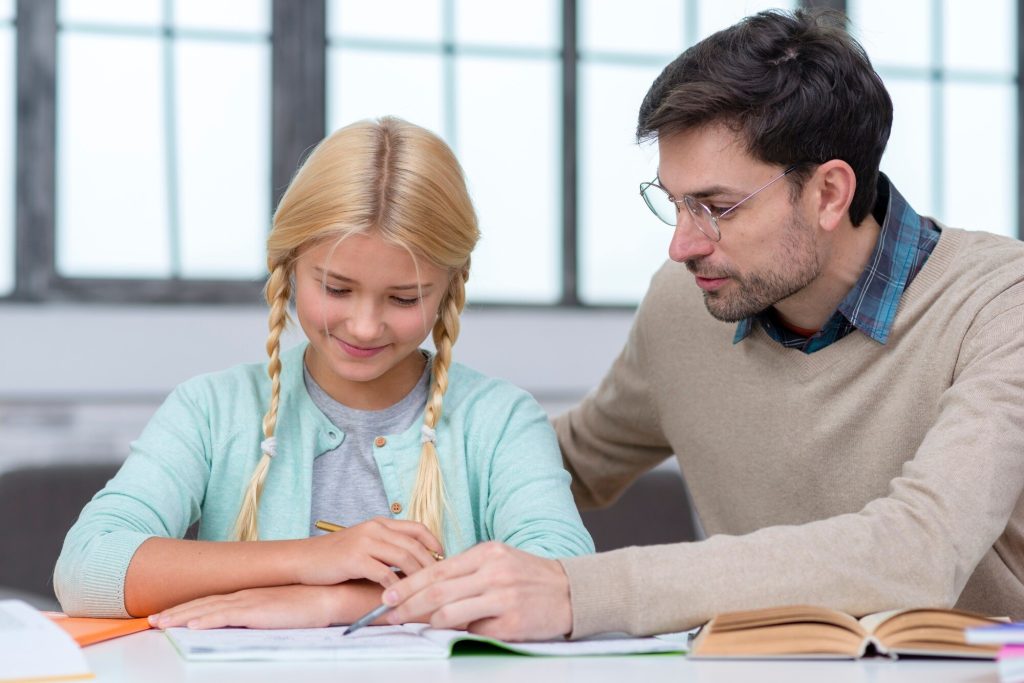 Experienced A-Level home tutor providing personalized instruction to student in comfortable Dubai home environment" Usage: Hero section background